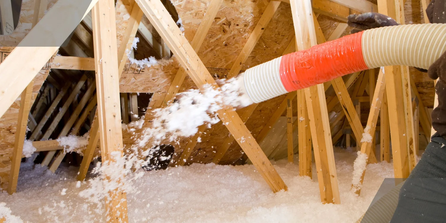 Insulation being professionally blown into an attic